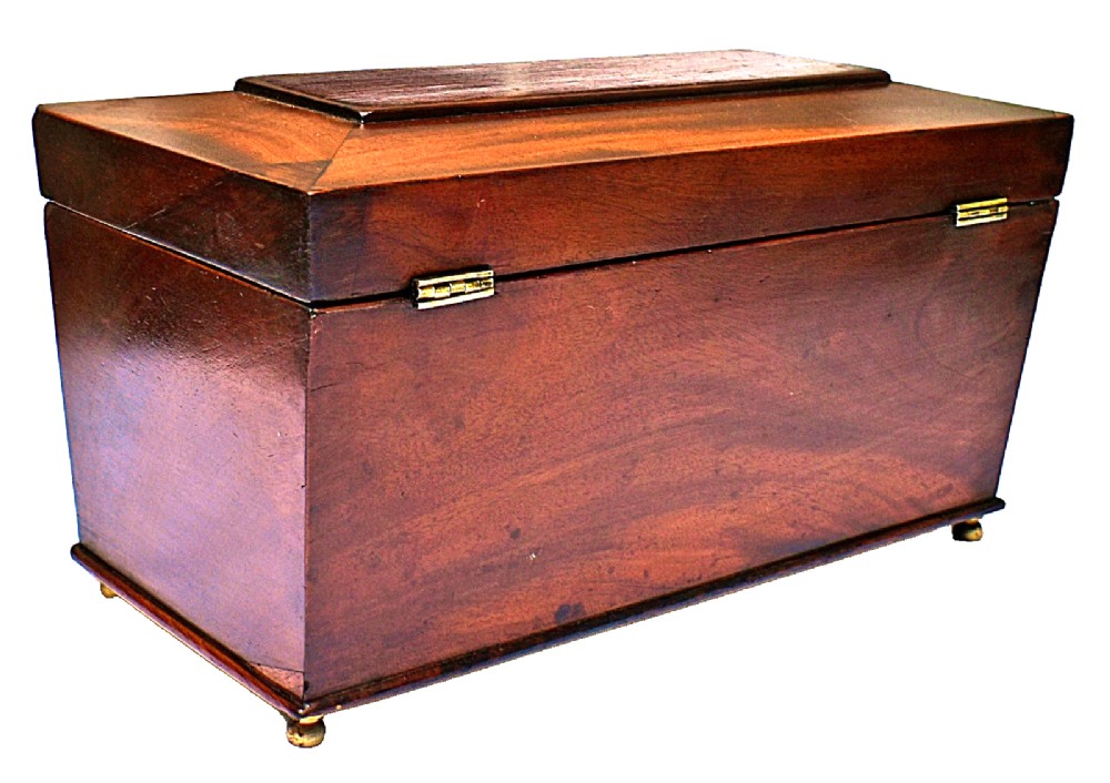 An open Victorian mahogany sarcophagus-shaped tea caddy featuring two lidded compartments, a central cut glass mixing bowl, marbled paper lid lining, and a key with a golden tassel. View VII