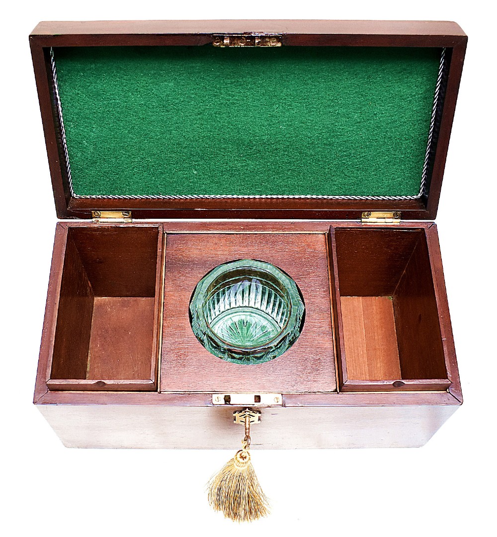 An open rectangular dark wood tea caddy featuring two internal covered compartments, a central cut glass mixing bowl, a green fabric-lined lid, and a key with a tassel inserted in the front lock. View VII