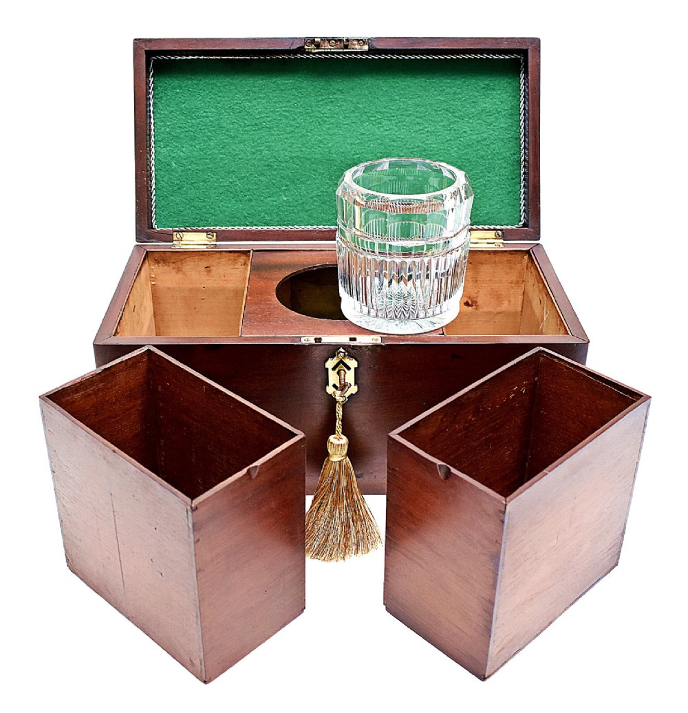 An open rectangular dark wood tea caddy featuring two internal covered compartments, a central cut glass mixing bowl, a green fabric-lined lid, and a key with a tassel inserted in the front lock. View IX