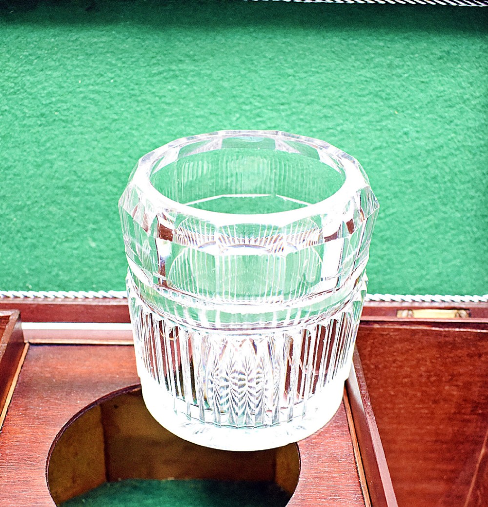 An open rectangular dark wood tea caddy featuring two internal covered compartments, a central cut glass mixing bowl, a green fabric-lined lid, and a key with a tassel inserted in the front lock. View XI