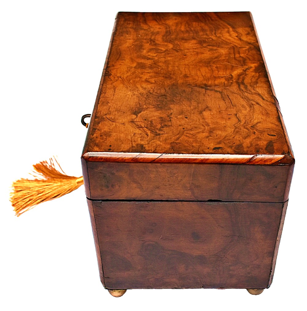 A rectangular mid-Victorian tea caddy crafted from figured burr walnut veneer with a central brass keyhole escutcheon and key. View III