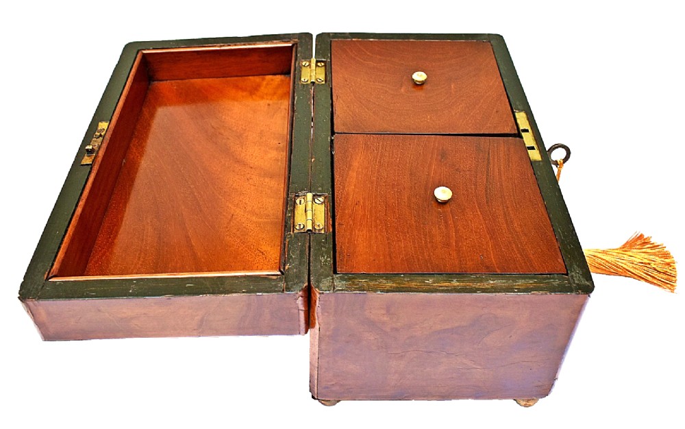 A rectangular mid-Victorian tea caddy crafted from figured burr walnut veneer with a central brass keyhole escutcheon and key. View V