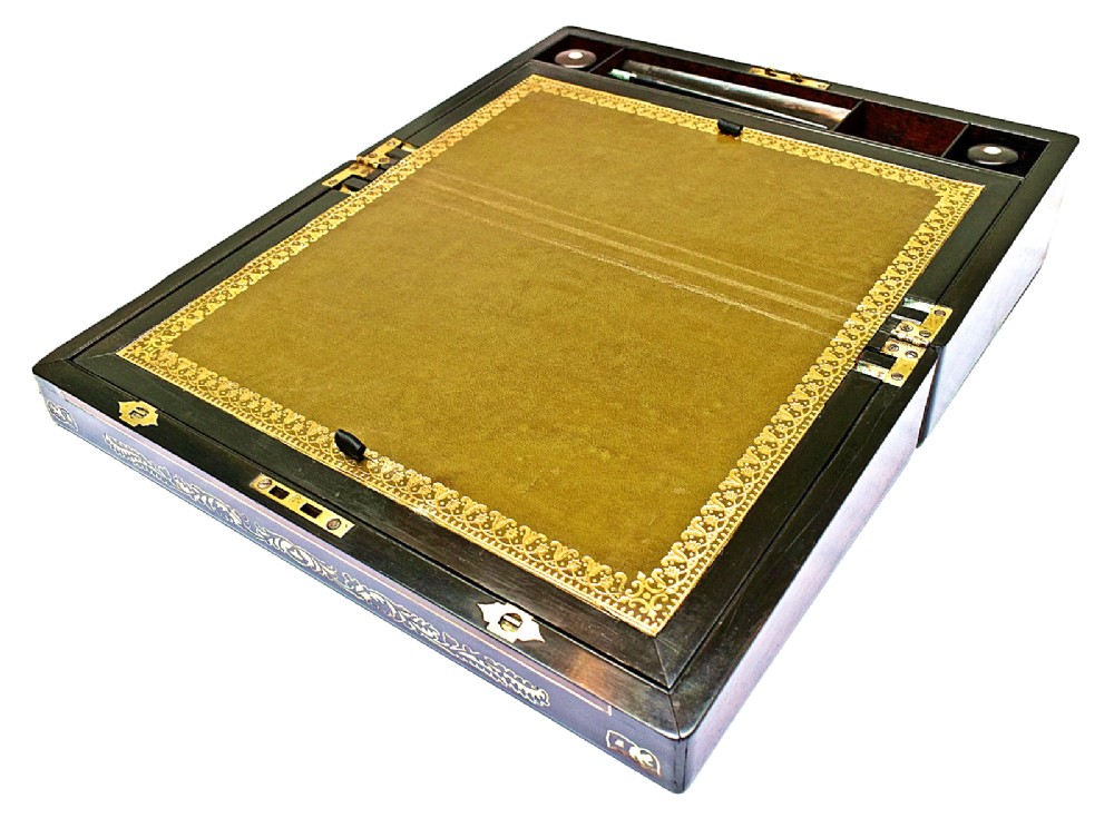 A dark rosewood writing slope with intricate mother-of-pearl floral inlays along the borders and a brass key with tassel attached to the front lock. View II