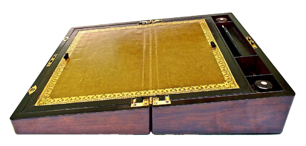 A dark rosewood writing slope with intricate mother-of-pearl floral inlays along the borders and a brass key with tassel attached to the front lock. View IV