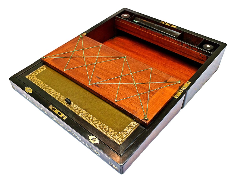 A dark rosewood writing slope with intricate mother-of-pearl floral inlays along the borders and a brass key with tassel attached to the front lock. View IX