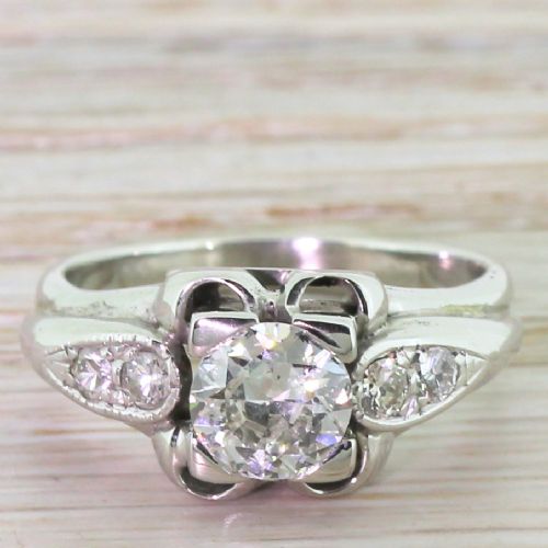 fig 1. A mid-twentieth-century platinum engagement ring featuring a central old European cut diamond set in a sculpted architectural mount with shoulder accents.