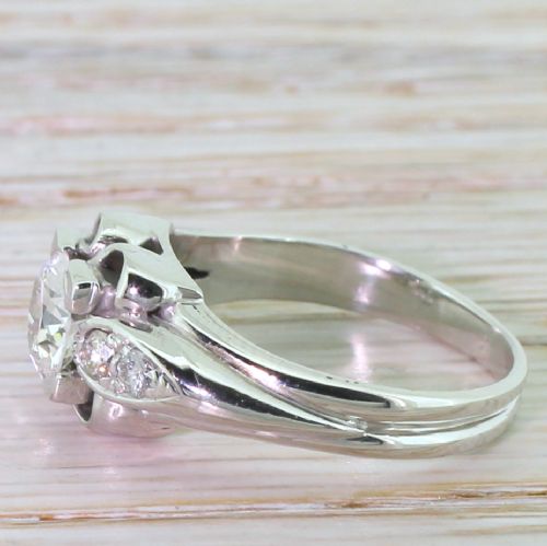 fig 2. A mid-twentieth-century platinum engagement ring featuring a central old European cut diamond set in a sculpted architectural mount with shoulder accents.