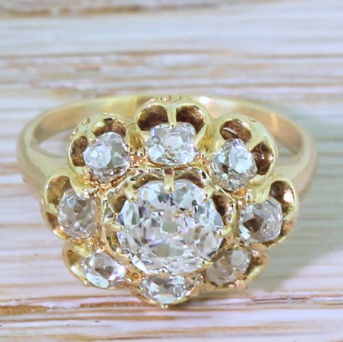 fig 1. A Victorian yellow gold ring featuring a central old cut diamond surrounded by a halo of smaller diamonds in a scalloped cluster setting.