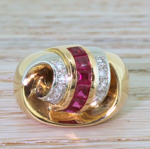 fig 1. A French mid-century yellow gold cocktail ring featuring a central channel of square red synthetic rubies flanked by diamond-set bands.