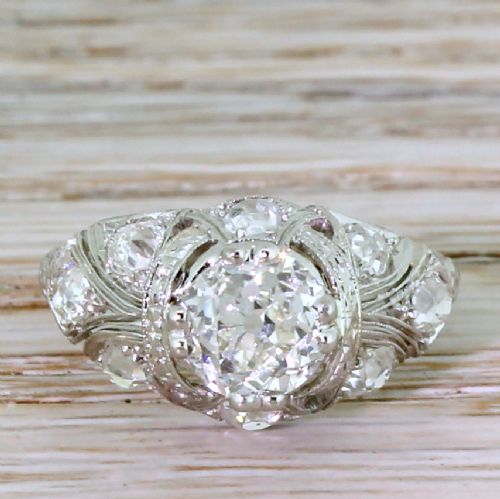 fig 1. An Edwardian platinum ring featuring a central old European cut diamond set within intricate pierced scrollwork and smaller accent diamonds.