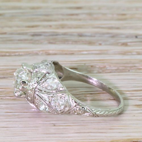 fig 2. An Edwardian platinum ring featuring a central old European cut diamond set within intricate pierced scrollwork and smaller accent diamonds.