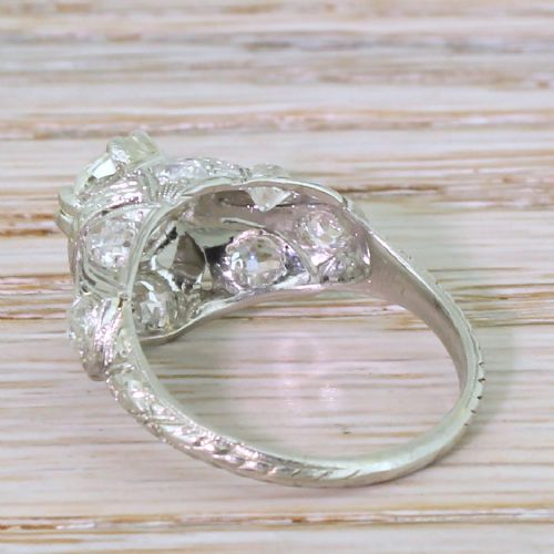 fig 3. An Edwardian platinum ring featuring a central old European cut diamond set within intricate pierced scrollwork and smaller accent diamonds.