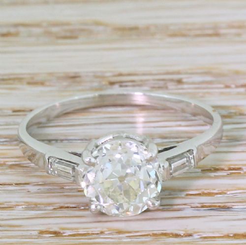 fig 1. An Art Deco solitaire engagement ring featuring a central old European cut diamond set in platinum with baguette cut side diamonds.