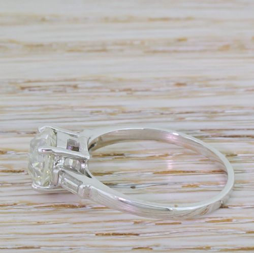 fig 2. An Art Deco solitaire engagement ring featuring a central old European cut diamond set in platinum with baguette cut side diamonds.