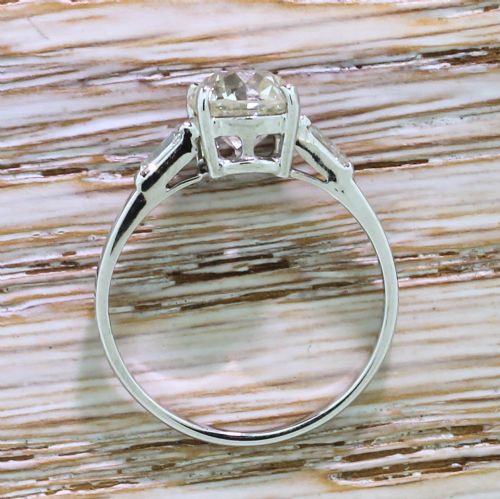 fig 3. An Art Deco solitaire engagement ring featuring a central old European cut diamond set in platinum with baguette cut side diamonds.