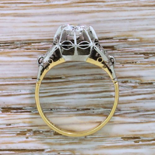 fig 3. A mid-century engagement ring featuring a transitional cut diamond set in a white metal head with carved shoulder accents on an 18ct yellow gold band.