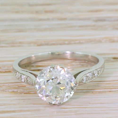fig 1. An Art Deco platinum engagement ring featuring a central old cut diamond in a multi-claw setting with accent diamonds on the shoulders.