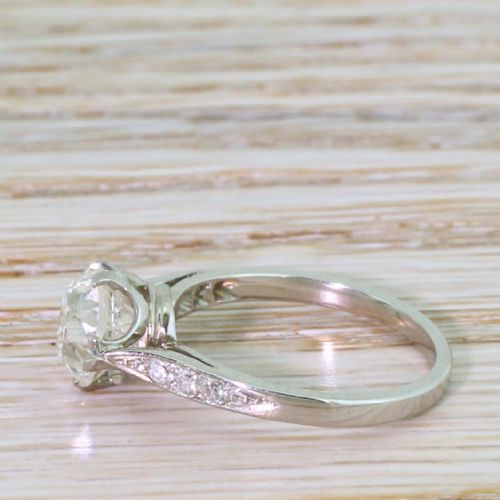 fig 2. An Art Deco platinum engagement ring featuring a central old cut diamond in a multi-claw setting with accent diamonds on the shoulders.