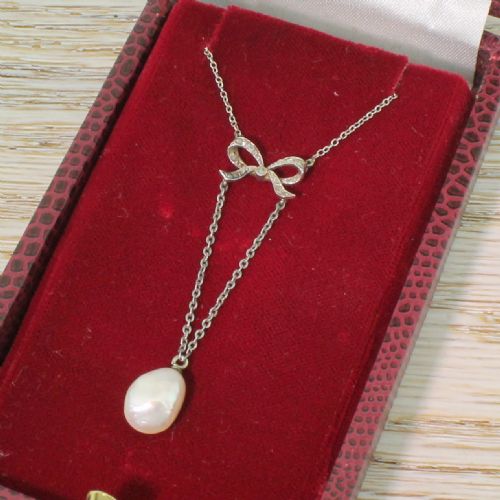 Edwardian Natural Pearl & Diamond Bow Pendant, Circa 1910