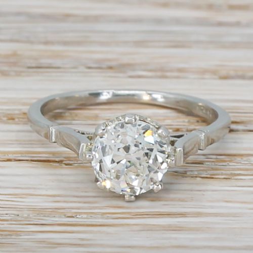 fig 1. An Art Deco platinum engagement ring set with a central round old European cut diamond and structured shoulders.