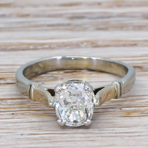 fig 1. An Art Deco diamond engagement ring featuring a central cushion-shaped old cut diamond set in platinum with detailed shoulders.