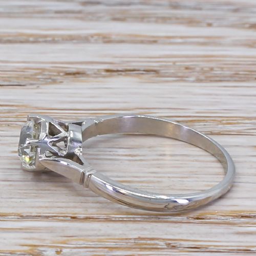 fig 2. An Art Deco diamond engagement ring featuring a central old cut diamond set in platinum with reeded shoulders.