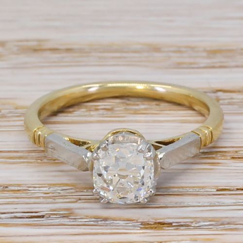 fig 1. An Art Deco diamond engagement ring featuring a central round old cut diamond in a multi-claw platinum setting on a yellow gold band.