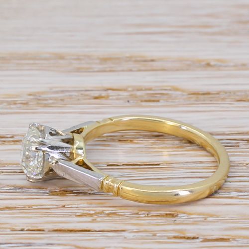 fig 2. An Art Deco diamond engagement ring featuring a central round old cut diamond in a multi-claw platinum setting on a yellow gold band.