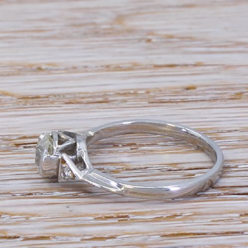 fig 2. An Art Deco engagement ring featuring a central round old cut diamond set in a platinum band with triangular geometric shoulders.