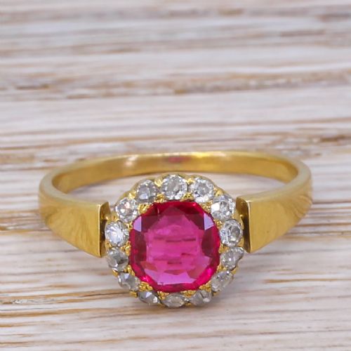 fig 1. A Victorian yellow gold ring featuring a central cushion-cut pinkish-red Burmese spinel surrounded by a halo of small diamonds.