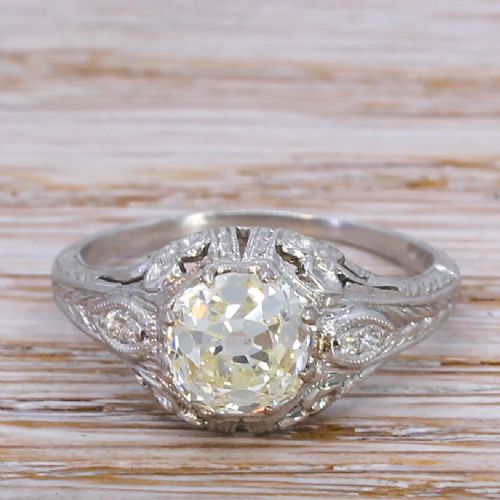 fig 1. An Edwardian platinum engagement ring featuring a central old cut diamond set within intricate filigree metalwork.