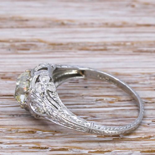 fig 2. An Edwardian platinum engagement ring featuring a central old cut diamond set within intricate filigree metalwork.