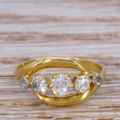 fig 1. A Victorian yellow gold crossover ring set with five graduated old cut diamonds along a curved band.