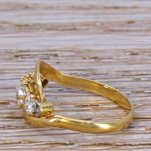 fig 2. A Victorian yellow gold crossover ring set with five graduated old cut diamonds along a curved band.