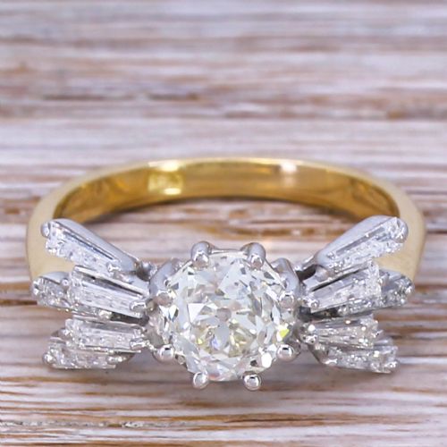 fig 1. A Mid-Century diamond ring featuring a central round old-cut diamond flanked by fanned tapered baguette cut diamonds on a yellow gold band.