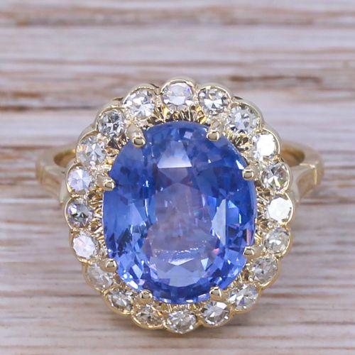 fig 1. An Art Deco cluster ring featuring a large oval Ceylon sapphire surrounded by a halo of round diamonds mounted on a gold band.