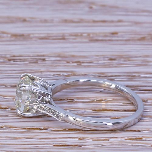 fig 2. An Art Deco platinum engagement ring set with a central old cut diamond held in claw settings with delicate millegrain shoulders.