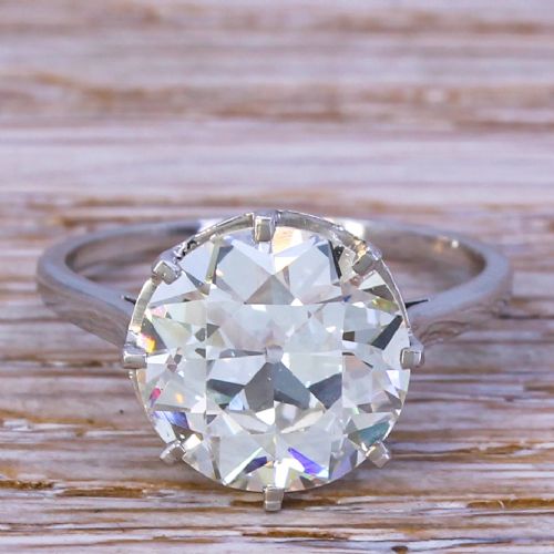 fig 1. An Art Deco diamond solitaire ring featuring a large round Old European cut diamond held in a multi-prong setting on a smooth metal band.