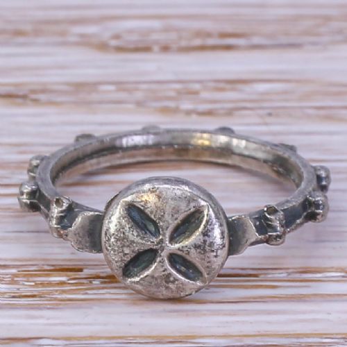 fig 1. An 18th-century aged silver decade rosary ring featuring ten raised nodes around the band and a circular bezel engraved with a four-petaled cross.