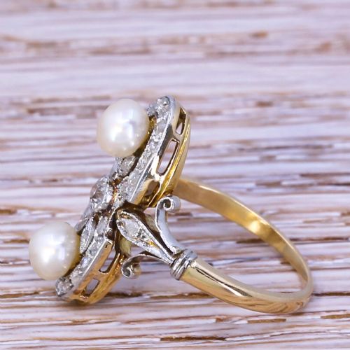fig 2. An elongated Art Nouveau gold ring set vertically with two white natural pearls surrounded by rose-cut diamonds in an openwork mount.