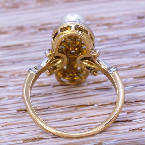 fig 3. An elongated Art Nouveau gold ring set vertically with two white natural pearls surrounded by rose-cut diamonds in an openwork mount.