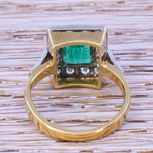 fig 3. An Art Deco ring featuring a rectangular emerald framed by a halo of diamonds set in platinum with a yellow gold band.