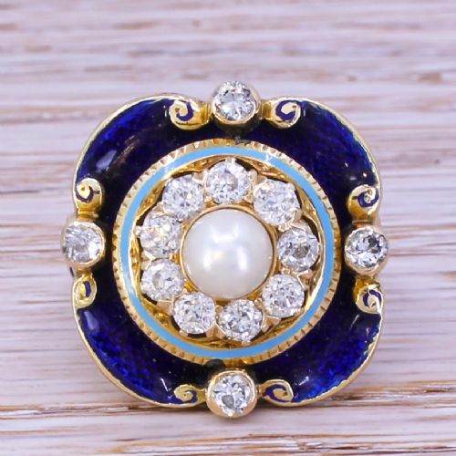 fig 1. A late Victorian gold ring featuring a central pearl surrounded by a diamond halo, light blue border, and royal blue enamel scalloped frame.