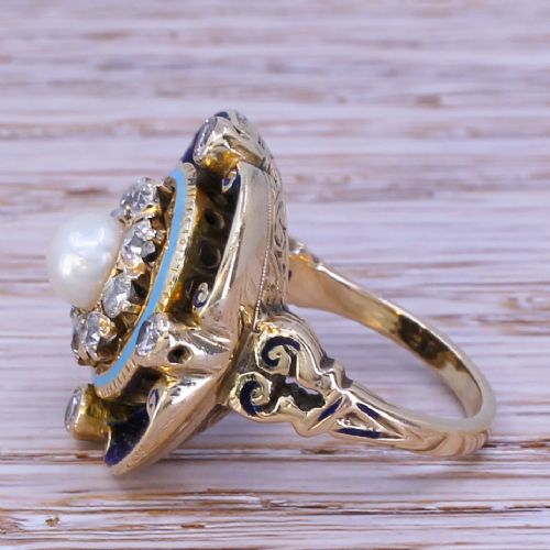 fig 2. A late Victorian gold ring featuring a central pearl surrounded by a diamond halo, light blue border, and royal blue enamel scalloped frame.