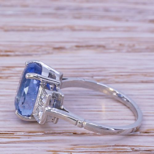 fig 2. A mid-century platinum ring featuring an oval cut blue Ceylon sapphire in a four claw setting flanked by rectangular diamond set shoulders.