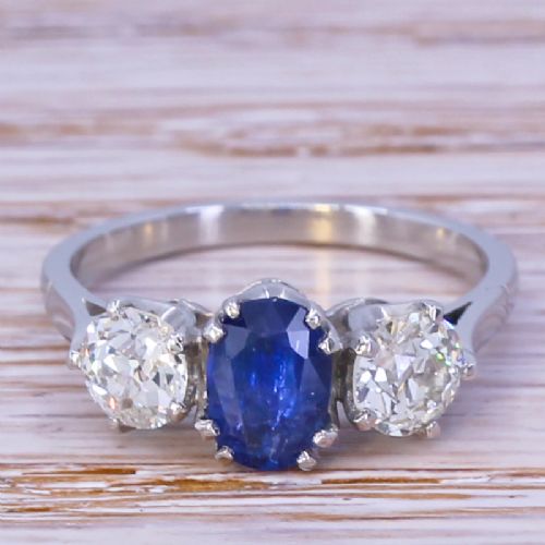 fig 1. An Art Deco trilogy ring featuring a central oval blue sapphire flanked by two round old cut diamonds set in platinum.