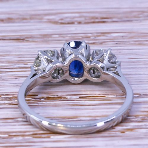 fig 3. An Art Deco trilogy ring featuring a central oval blue sapphire flanked by two round old cut diamonds set in platinum.