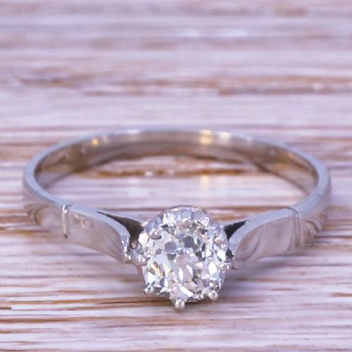 fig 1. A mid-century white gold solitaire engagement ring featuring a single central old cut diamond in a multi-claw setting with sculpted shoulders.