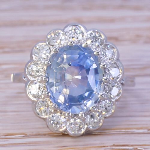 fig 1. An Art Deco ring featuring an oval light blue Ceylon sapphire centered within a scalloped halo of brilliant-cut diamonds on a platinum band.