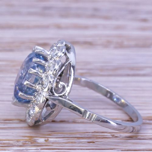fig 2. An Art Deco ring featuring an oval light blue Ceylon sapphire centered within a scalloped halo of brilliant-cut diamonds on a platinum band.
